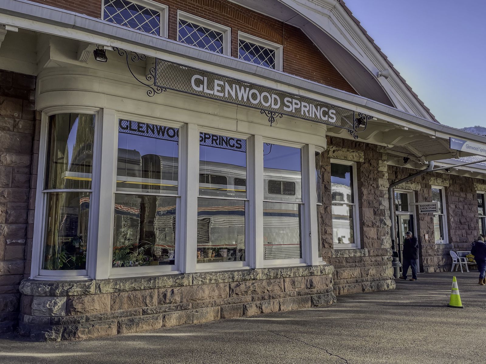 The eastbound California Zephyr is seen in the reflection of the windows of the Gleenwood Springs, CO station.
