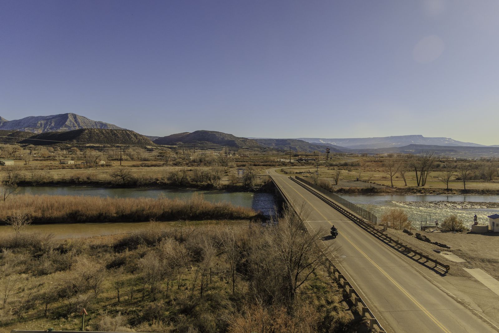 A motocyclist crosses the Colorado River in De Beque Colorado